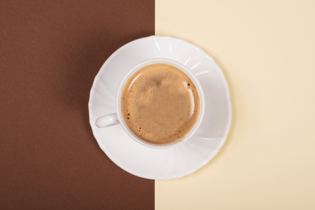 White cup of coffee on double-tone backgroundの写真素材