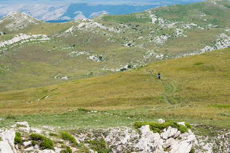 Mountanious scenic empty landscape with walking tourists.の写真素材