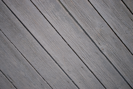 Background of many grey not painted aged planks with minor natural defects set in diagonal.の写真素材