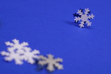 White paper snowflakes on dark blue background with copy space. Winter concept.の写真素材