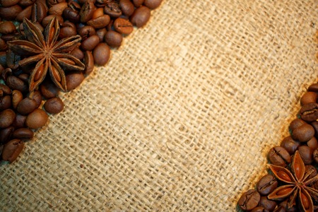 Coffee beans and anise stars on burlap creating space for text.の写真素材