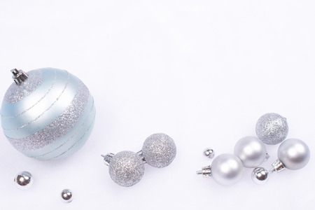 Beautiful shiny and glittering delicate light-blue and silver baubles on the background of...