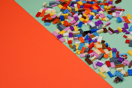 Colorful plastic construction toys on white background, scattered building blocks. Space for text.の写真素材