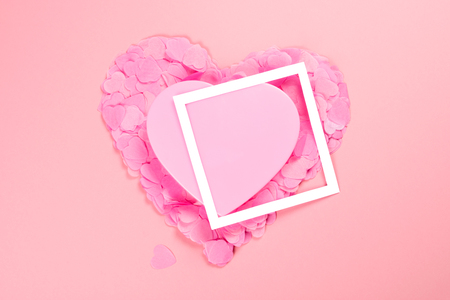 Pink heart of heart-shaped confetti with a frame.の写真素材