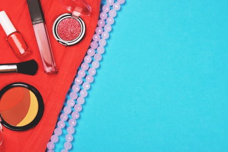Make up and fashion woman essentials: cosmetics, make-up accessories, necklace and piece of cloth of...