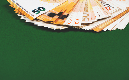 Fan of fifty euro banknotes on a green background with copy space for text. Budgeting, finance and saving concept.の写真素材