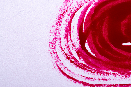 Close up of red nail polish stroke mark and lines with visible texture isolated on white as a make-up sample with copy space. Beauty, fashion and art concept.の写真素材