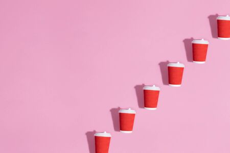 Pattern of paper cups on pink background.の写真素材