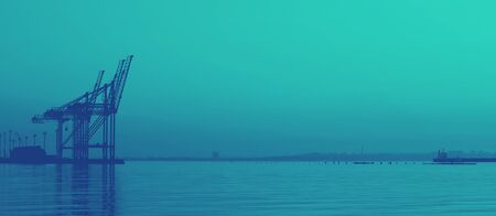 Beautiful morning at the sea. Huge cargo cranes, ships and silhouettes of city buildings at the dawn...