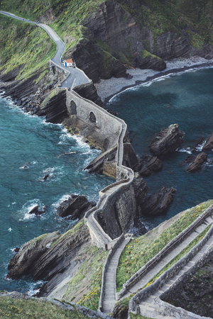Sunset in the mountain natural coast landscape. Green valley on background dramatic sky, clouds, sea ocean. Panorama horizon perspective view of stairs in Northern Spain alps. Travel mockup conceptの写真素材
