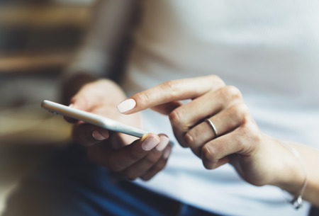 Women using smartphone isolated, hipster manager holding mobile gadget, girl texting message sms, connect concept, blur background mockup, female hands touch digital screen, user social networkの写真素材