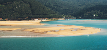 Observation deck in trip holiday in northern spain, top view on seascape on green mountain and sand island in ocean, background panoramic view of the city landscape. Nature travel concept, surfer wavesの写真素材