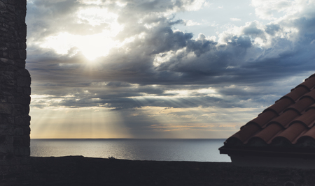 Clouds blue sky and sunlight sunset on horizon ocean . ÃÂ¡loudscape on background seascape dramatic atmosphere rays sunrise. Relax view waves sea with ship, mockup nature evening concept.の写真素材