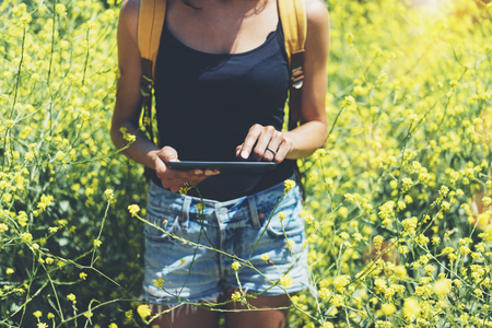 Hipster texting message on tablet computer, mockup of blank empty screen.の写真素材