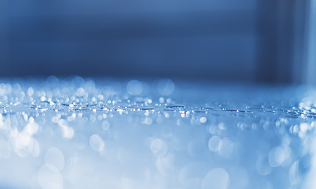 Blue glass with raindrops background texture horizontal top view isolated, rain on the window backdrop, abstract light bokeh and defocus drops, clear water on space blank back outdoors, mockup rainy nutureの写真素材