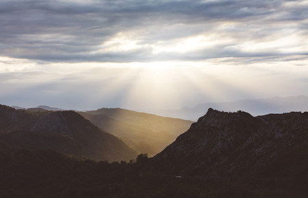 Sunset in the mountain natural landscape park. Green valley on background dramatic sky and clouds. Panorama  horizon view of scenery  foggy hills Northern Spain alps. Travel mockup concept in evening time.の写真素材