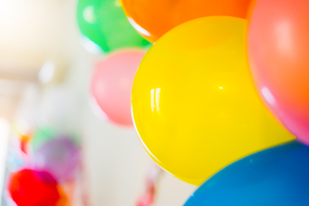 colorful bright holiday balloons close-up, background for text, happy birthday party concept, celebration decorationの写真素材