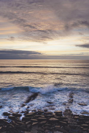 Sunlight sunset on horizon ocean on background seascape atmosphere rays sunrise. Relax view waves sea on evening sand beach, sun light flare nature evening outdoor vacation concept, verticalの写真素材