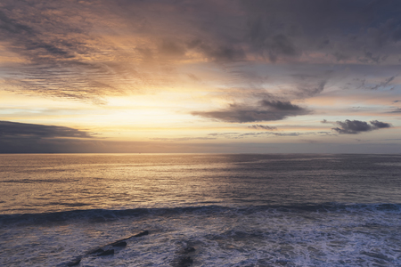 Sunlight sunset on horizon ocean on background seascape atmosphere rays sunrise. Relax view waves sea on evening sand beach, sun light flare nature evening outdoor vacation concept, copy space for textの写真素材