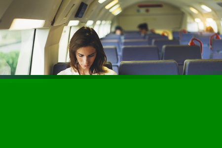 Enjoying travel. Young pretty woman traveling by train sitting near the window using smartphone and looking map. Tourist texting online message and plan route of railway, railroad transport conceptの写真素材