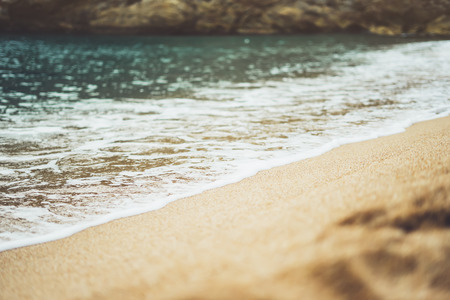 coastline beach on sunny day background of ocean, gold sand close up blur, tourism relax calm concept, seascape perspective vacation, summer seashore on blue sea waves and sand at sunset, mockupの写真素材