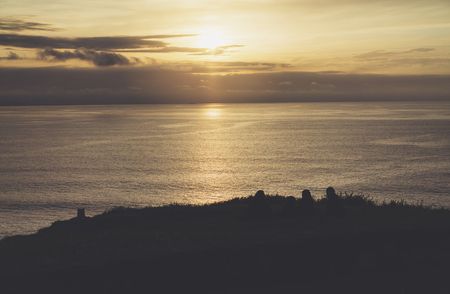 Clouds sky and sunlight sunset on horizon ocean. Silhouette person on background seascape dramatic atmosphere rays sunrise. Relax view waves water sea, mockup nature evening concept perspective sunriseの写真素材