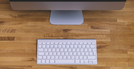 Top view of a computer monitor with a blank screen on a pure white background of a brick wall and a...