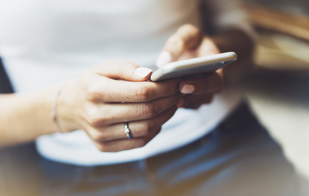 Women using smartphone isolated, hipster manager holding mobile gadget, girl texting message sms, connect concept, blur background mockup, female hands touch digital screen, user social networkの写真素材