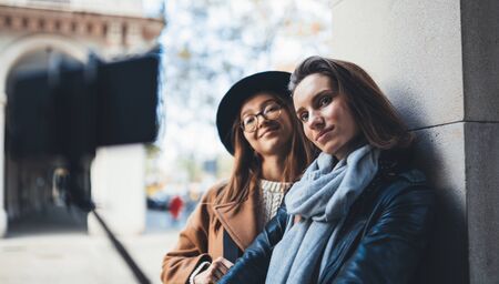 Girlfriends tourist taking photo selfie together on smartphone mobile. Blogger hipster travels in europe city. Vacation holiday friendship concept. Travelers self closeup on cellphone internet technologyの写真素材