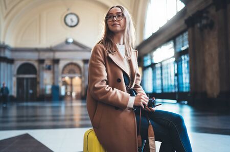 Tourist woman with suitcase on platform station in Barcelona. Girl photographer traveler waiting train enjoy holiday weekend vacation in transport railway. Travel railroad station conceptの写真素材