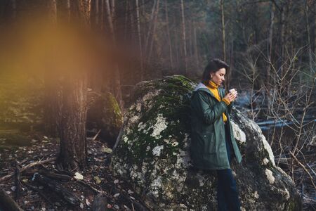 tourist traveler think relax green forest landscape,  woman drink hot tea rest nature trip, hiking leisureの写真素材