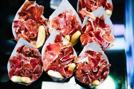 slice spanish hamon in barcelona market, jamon iberico isolated, traditional national spain meat in store, serrano prosciutto food on background gastronomy, bacon berianの写真素材