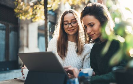 Freelancer communicate on project, friends shopping online on wifi tablet in cafe outdoor. Students studies on internet. Working business process conceptの写真素材