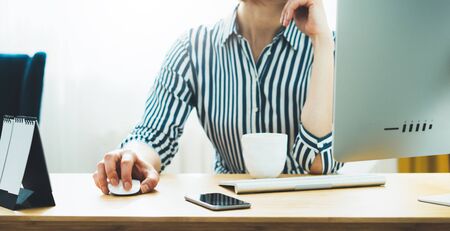 female hands using computer mouse at home, isolation girl working at office workplace, social...