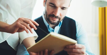 colleague designer consultant discuss startup project. Bearded young businessman working at office. Director man with managers meeting. Idea, alalyze marketing plans. Workplace teamwork conceptの写真素材