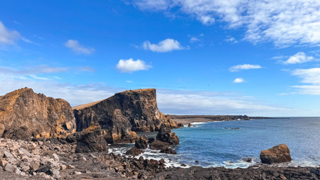View of the Atlantic Ocean from the rocky coastline of Iceland. Photos of Iceland landscapes, beautiful clouds and calm ocean in springの写真素材