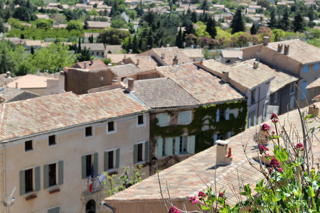 Typical street with old houses of a village in La Provence, wooden window, beautiful view, focus on the flowers, blurred background, outdoorsの写真素材