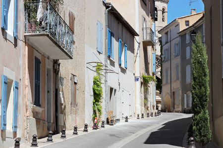 Typical street with old houses of a village in La Provence, wooden doors, windows, old street lamps, beautiful view, outdoorsの写真素材
