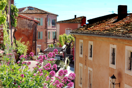 Typical street with old houses of a village in La Provence, wooden window, beautiful view, focus on the flowers, blurred background, outdoorsの写真素材