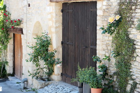 Typical street with old houses of a village in La Provence, wooden doors, beautiful view, outdoorsの写真素材