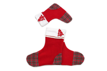Three red Christmas socks with tree decor for Santa gifts arranged like an upward arrow on white background, winter holidays symbolの写真素材