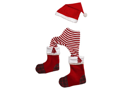 Christmas clothes and attributes forming a little walking upward child on white background, winter holiday symbolの写真素材