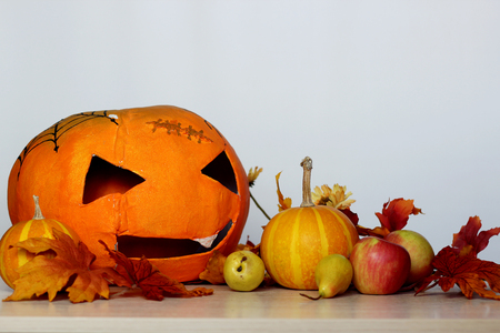 Beautiful autumn composition with Halloween pumpkin head jack lantern over white background, Halloween conceptの写真素材