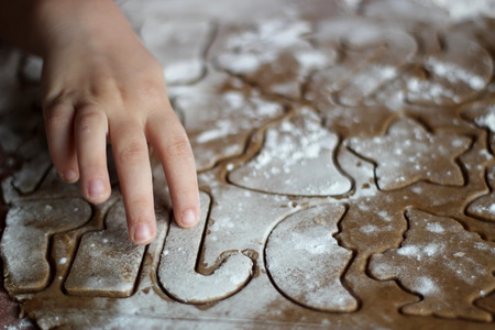 Close-up of hand of little child baking cookies for Santa Claus, happy family concept, winter holiday, selective focusの写真素材