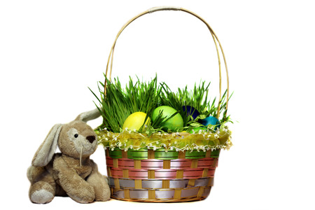 Easter basket with eggs decorated with the grass isolated over white background, traditional season...