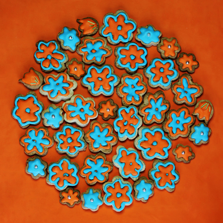 globe pattern of colorful cookies with glaze in the form of hearts over bright orange background, food and drink concept, valentine and mother dayの写真素材