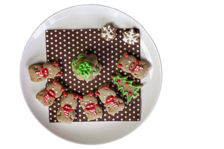 Festive Christmas plate with sweet cookies, tree, angel snowflakes and pigs, new year symbol, classical red and brown Christmas color, winter holidays conceptの写真素材