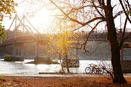 Gorgeous view of Kiev city in autumn, river, golden leaves and bridge, family weekend, active lifestyleの写真素材