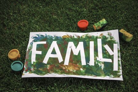 Cute toddler with darling hand print project kept his busy at home or outside at summer, drawing posters created with tape and fingers, easy and funny DIY with kids, early art education conceptの写真素材