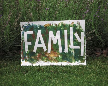 Cute toddler with darling hand print project kept his busy at home or outside at summer, drawing posters created with tape and fingers, easy and funny DIY with kids, early art education conceptの写真素材